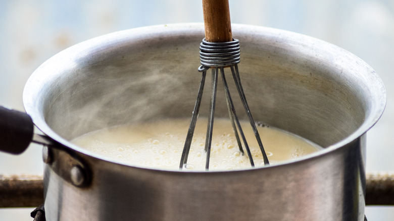 whisk in a saucepan of boiling milk