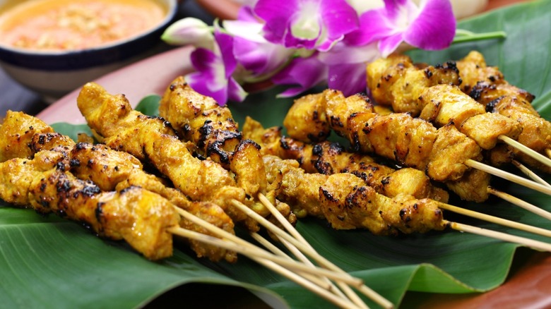 grilled chicken skewers on green cloth