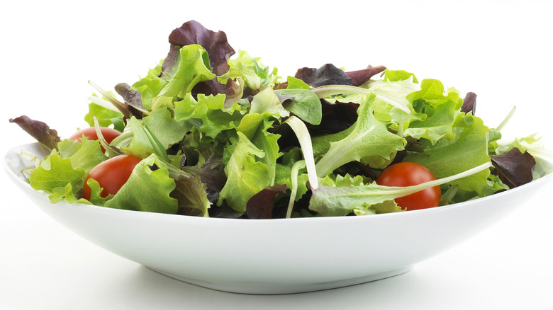 bowl of fresh salad greens and small tomatoes