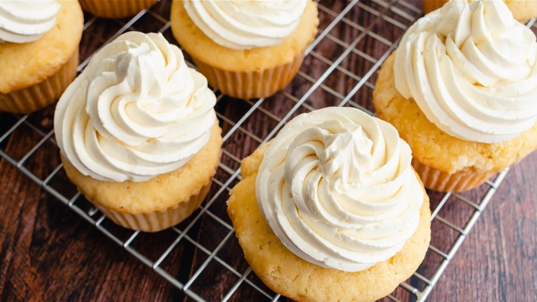 yellow cupcakes with swirls of white frosting 