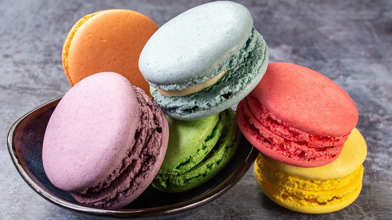 Black bowl filled with colorful macarons