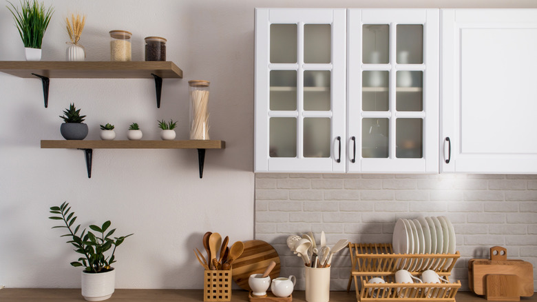 Kitchen with two floating shelves topped with plants