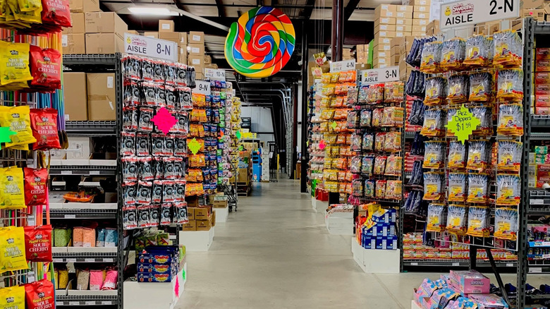 Many end camps with candy along aisles with a giant lollipop at the end at b.a. Sweetie Candy Company