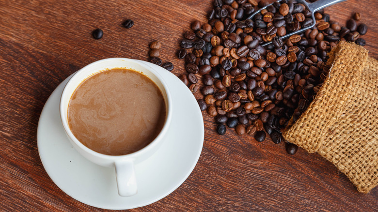 Coffee mug with coffee beans