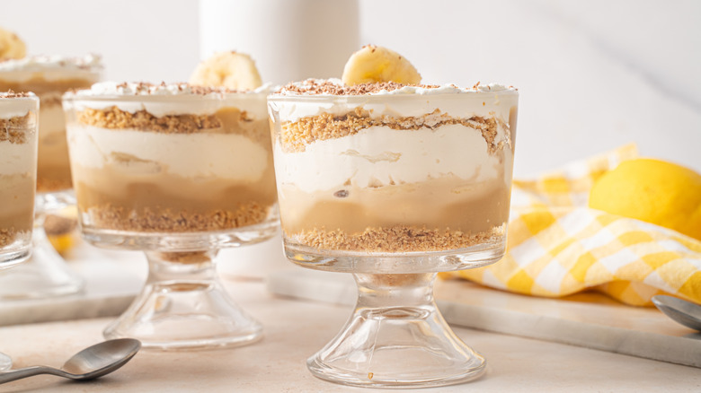 Banana pudding in glass jars topped with sliced banana