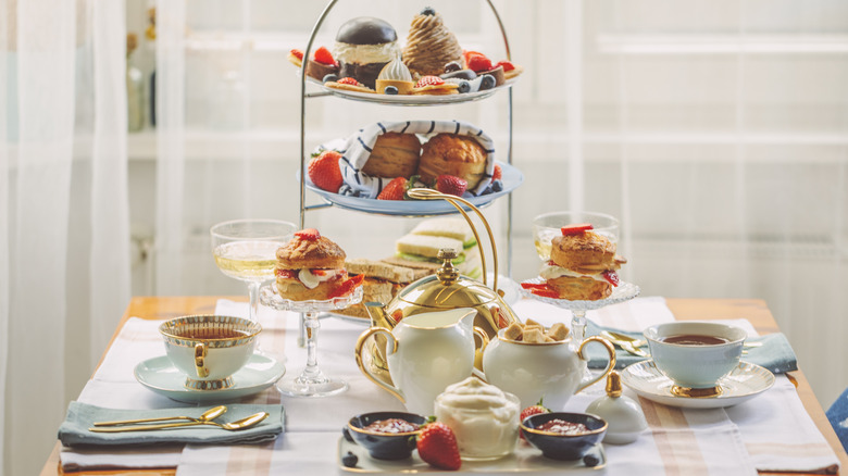 A fancy tea party spread on a wooden table