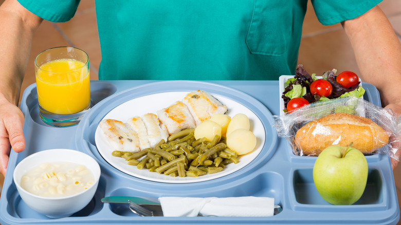 man holding tray of different foods