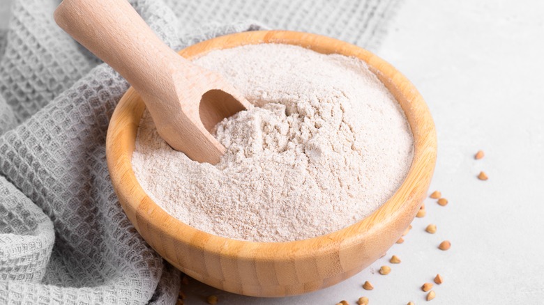 Bowl of flour with wooden scoop