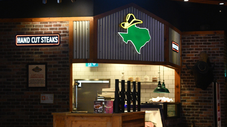 A Texas Roadhouse chain interior with hand cut steaks sign