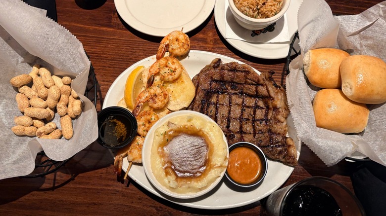 Texas Roadhouse meal consisting of steak, mashed potatoes, shrimp, and rice
