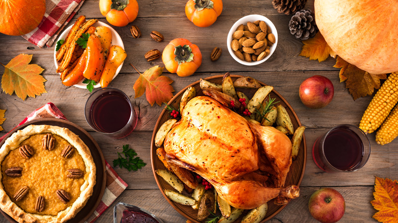 Thanksgiving feast surrounded by festive fall decorations