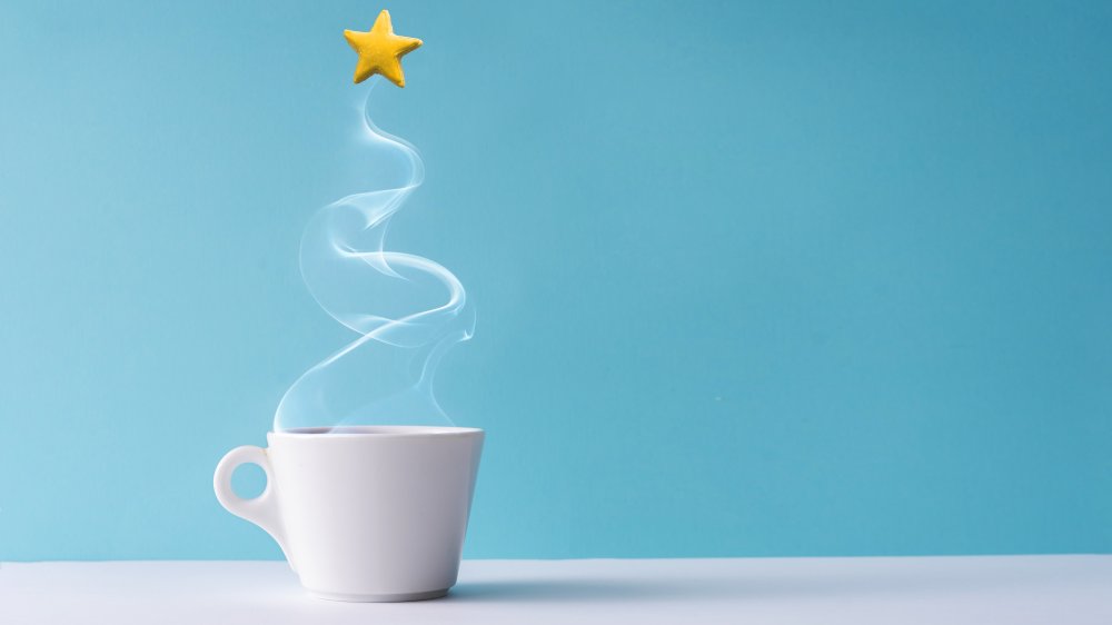 cup of coffee, steam in the shape of a tree, and a star