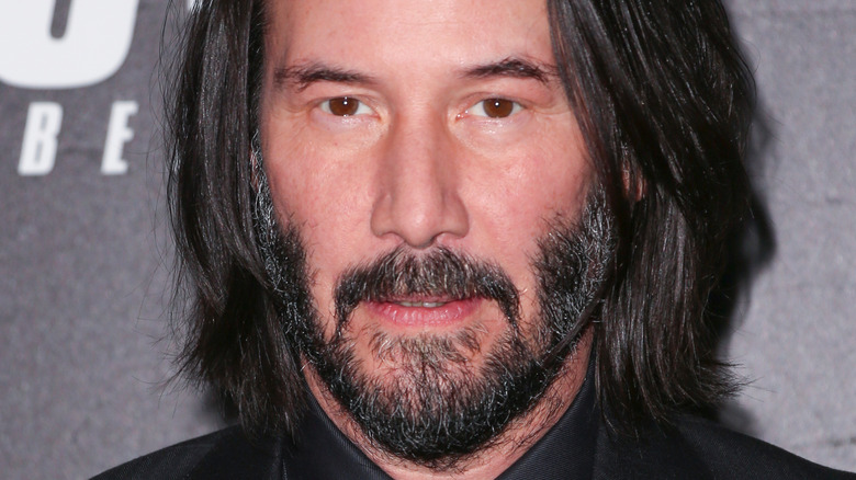 Keanu Reeves smirking at camera