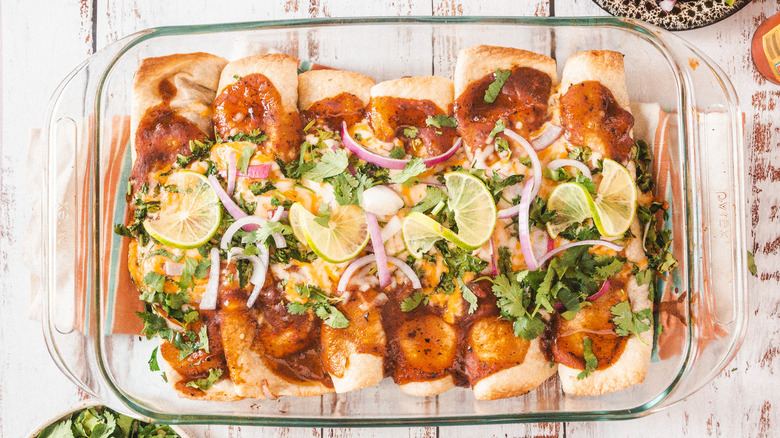 Chicken enchiladas in clear pan