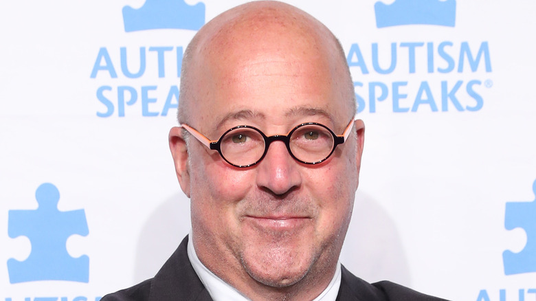 Andrew Zimmern wearing glasses