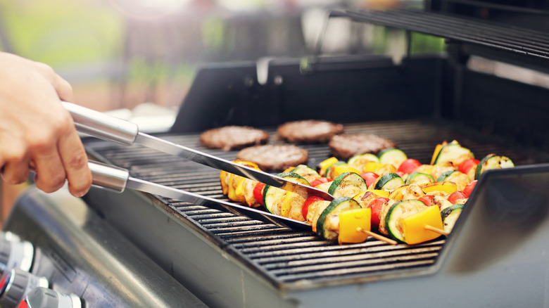 Man cooking on a gas grill