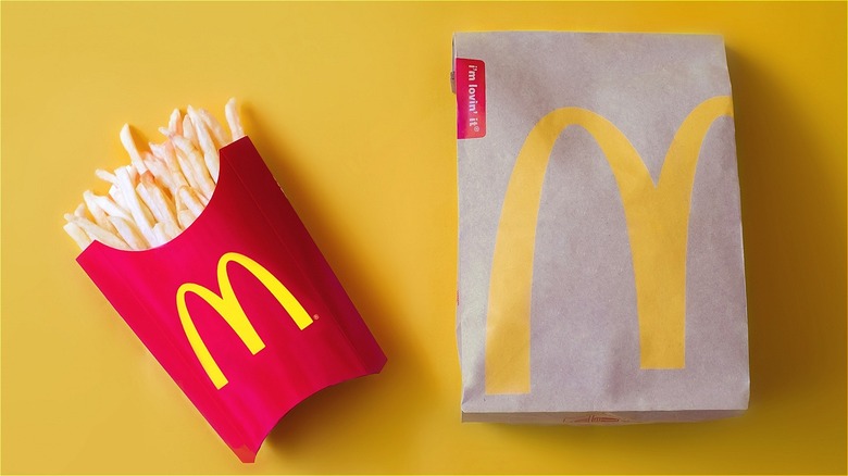 McDonald's fries and bag against a yellow background
