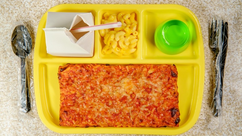 School lunch with pizza and milk seen from overhead