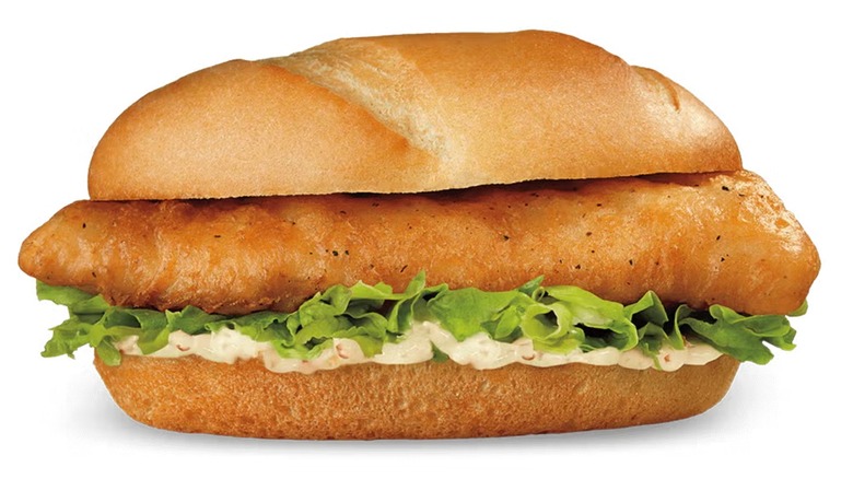 Culver's Northwoods Walleye Sandwich with tartar sauce and lettuce against white background