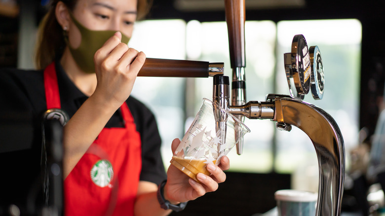 Starbucks barista pouring cold brew