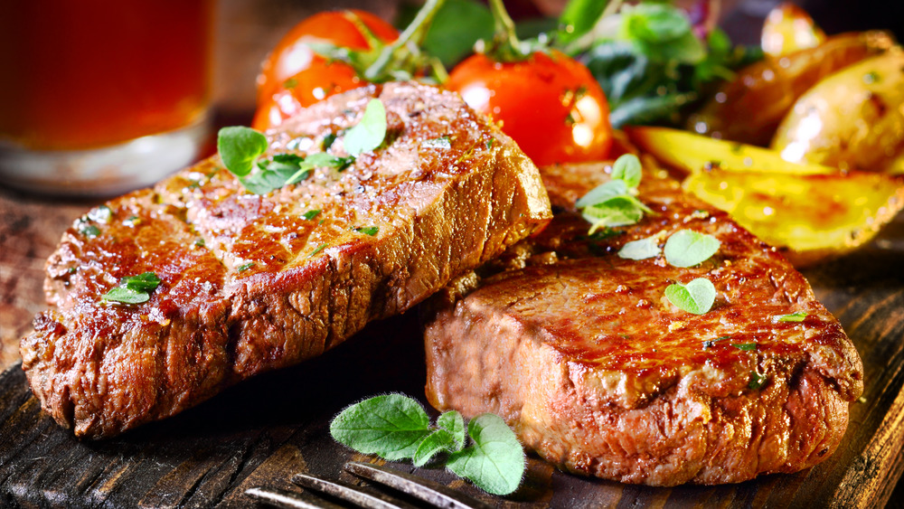Wood plank with steak on it