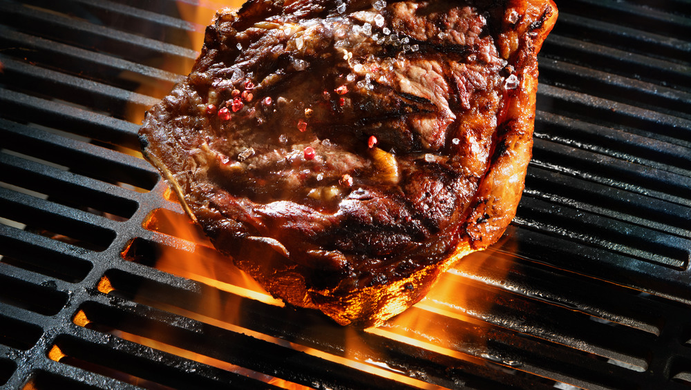 Steak cooking on a grill