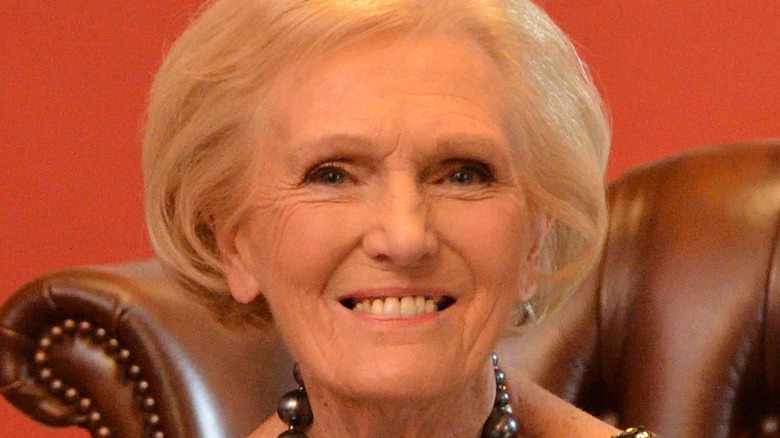 Mary Berry sitting at desk with her cookbooks