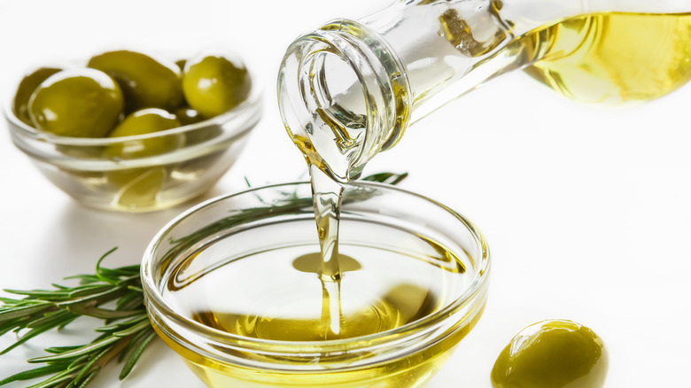 Olive oil pouring from bottle