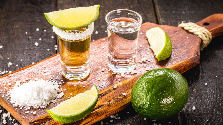 Shots of tequila on cutting board