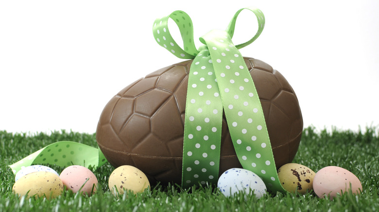 Oversize chocolate easter egg wrapped in ribbon