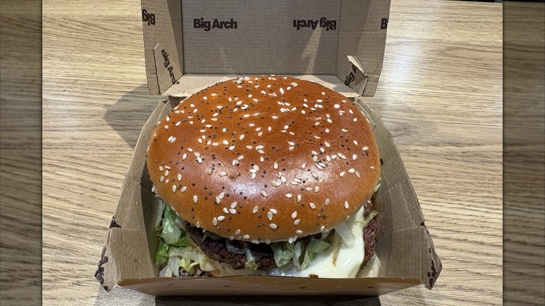 McDonald's Big Arch burger in box on restaurant table.