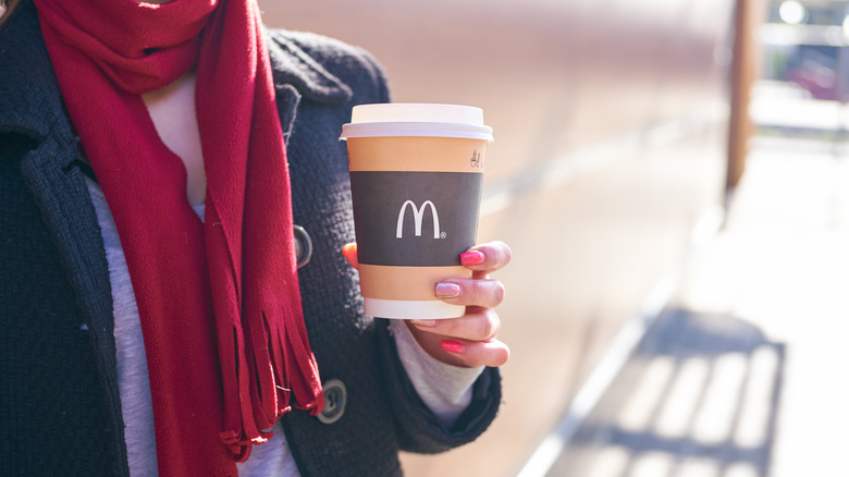Woman holding McDonald's cup