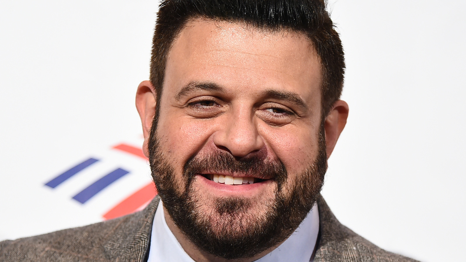 The Meat Cooking Tip Adam Richman Learned From His Mother
