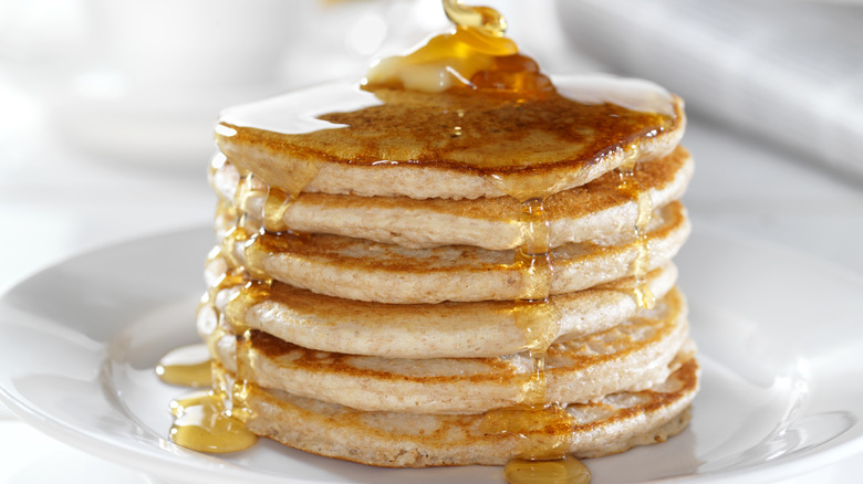 a stack of pancakes with butter and syrup