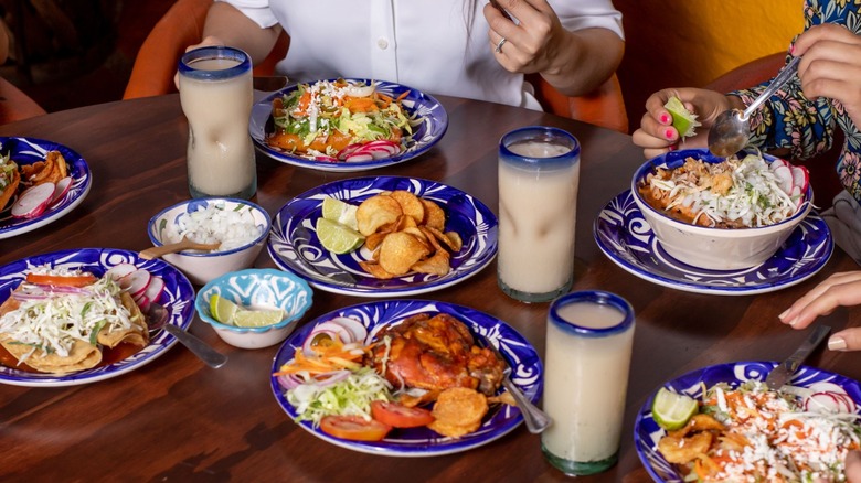 assortment of Mexican dishes on table at restaurant