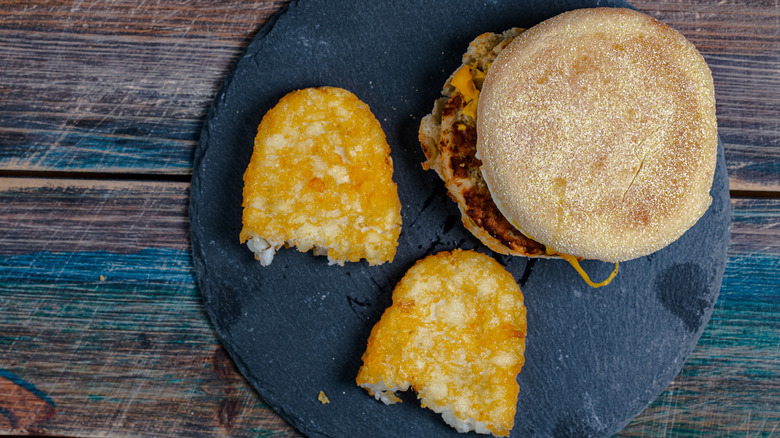 Overhead view of McMuffin and hash brown on serving tray