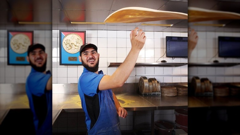 Zagros Jaff spinning a pizza at work 