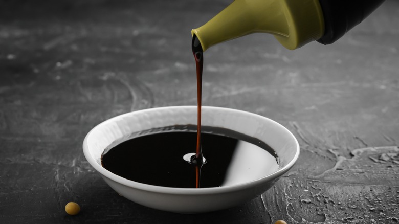 soy sauce pouring into bowl