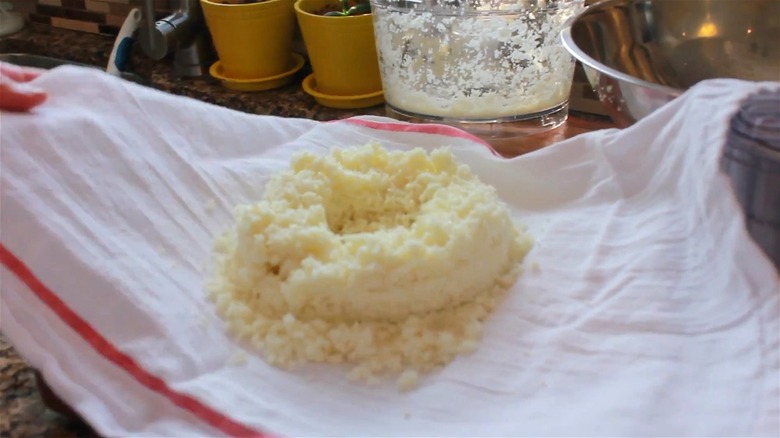 Cauliflower rice being dried on a towel.