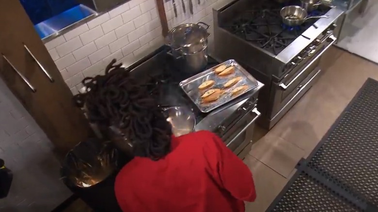 Chef on the set of Chopped looking at fire in garbage can
