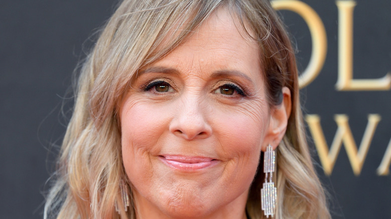 Mel Giedroyc smiling into the camera at a red carpet event