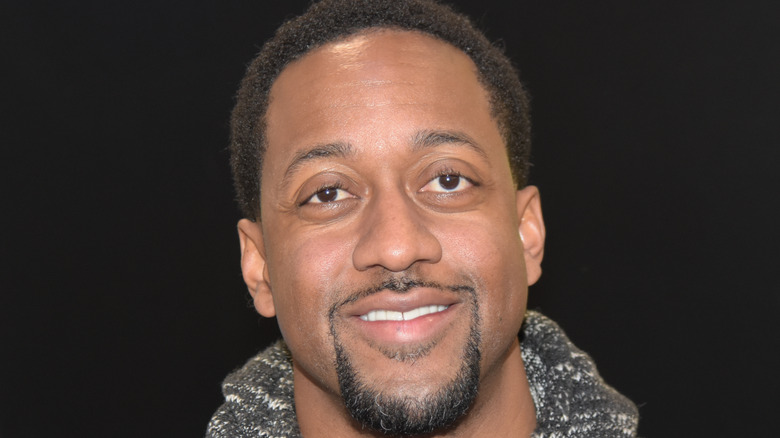 Jaleel white smiling on black background