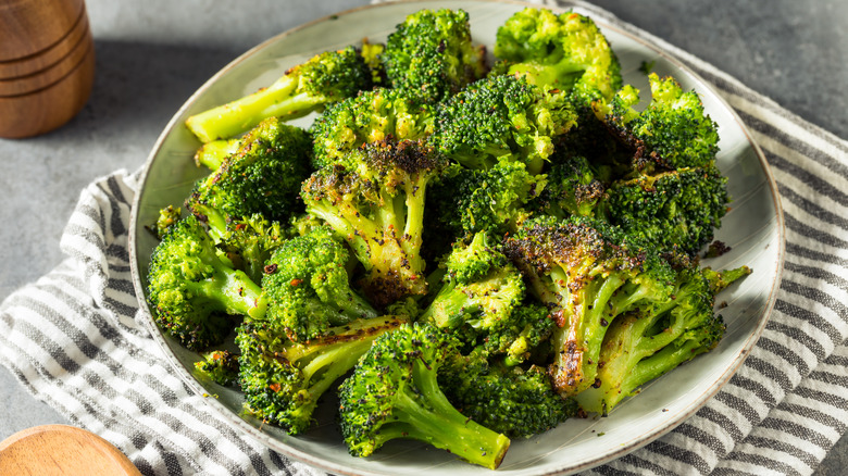 Roasted broccoli on white plate