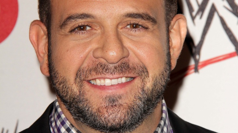 A close-up of Adam Richman wearing a checkered shirt