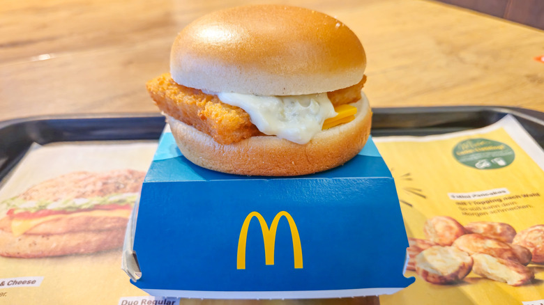Filet-O-Fish sandwich with tartar sauce sitting on top of a box from McDonald's