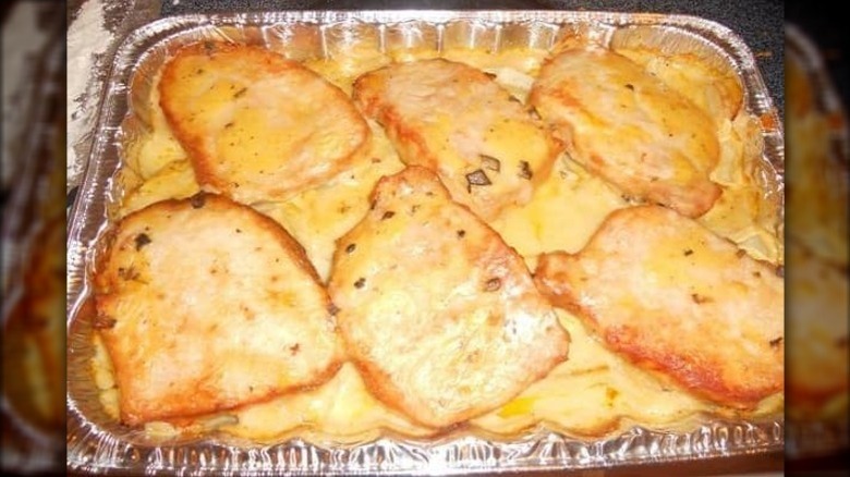 baking tin with pork chop and potato casserole