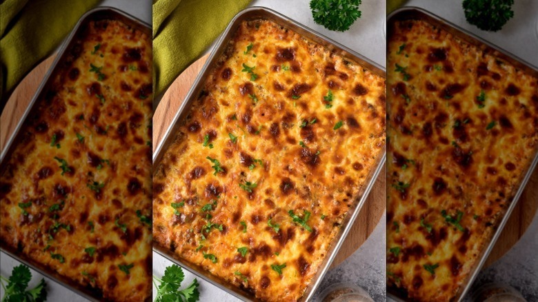 aerial shot of cheesy ground beef and rice casserole on a gray countertop
