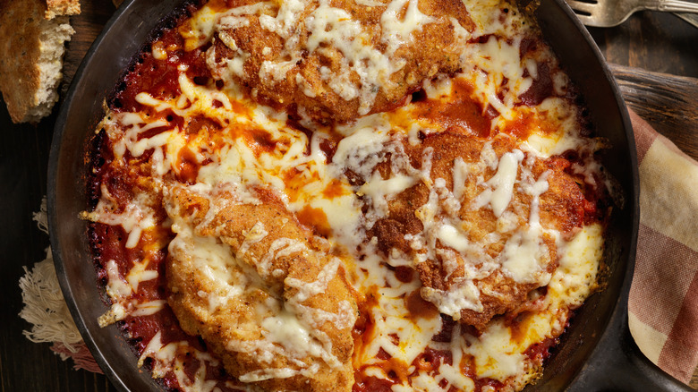 aerial image of chicekn parm casserole in a cast iron skillet