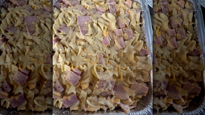 ham and noodle casserole in a tin baking dish