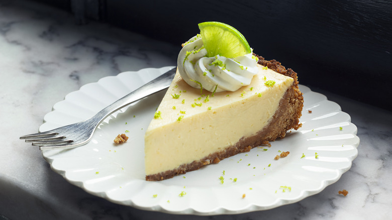 a slice of key lime pie on a plate with a fork
